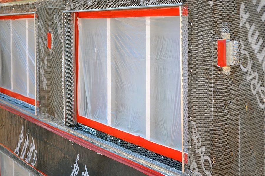 Red stucco masking tape application