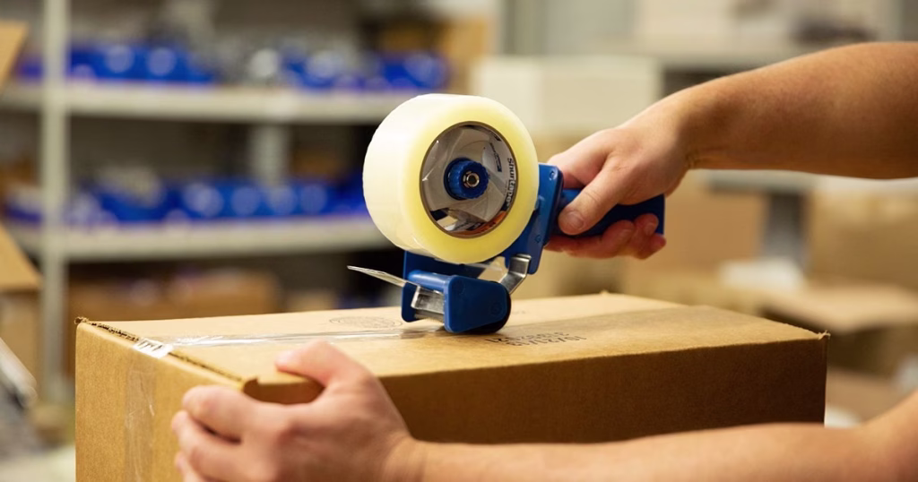 Sealing a box with acrylic tape using hand dispenser