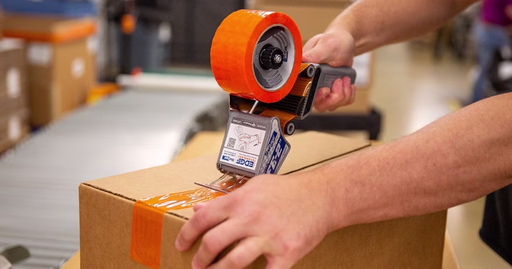 Shurtape Folded Edge hand dispenser on corrugate box